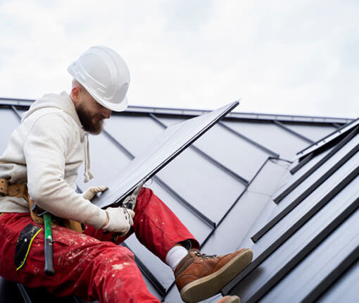 roofer repairs roof after storm