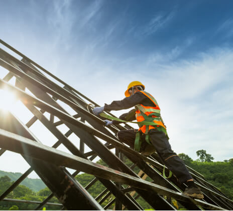 man builds roof at sunrise