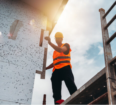 man constructs on scaffolding