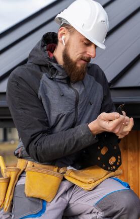man completes roof repair